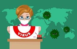 Grafika ilustrująca tekst przedstawia osobę, która przemawia na tle mapy świata atakowanej przez wirusy COVID-19.
